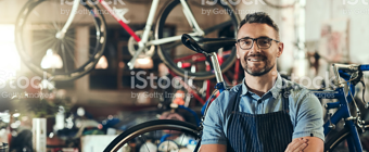 Smiling business owner in a bicycle shop
